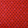 Red and black jersey fabric with polka dots and pink safety pins