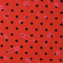 Red jersey fabric with small black polka dots and pink safety pins