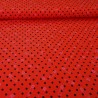 Red jersey fabric with small black polka dots and pink safety pins