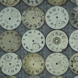 Beige and white clocks fabric on a gray background