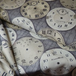 Beige and white clocks fabric on a gray background