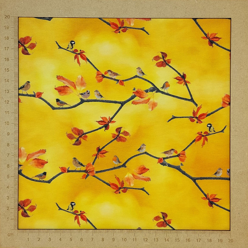 Yellow jersey fabric with small birds and tree branches