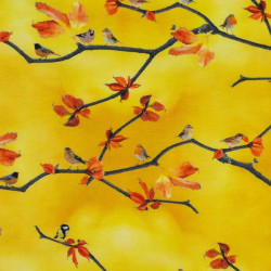 Yellow jersey fabric with small birds and tree branches