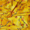 Yellow jersey fabric with small birds and tree branches